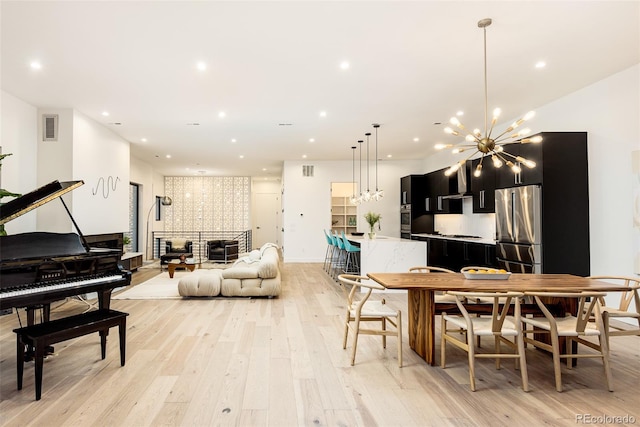 dining area with a chandelier and light wood-type flooring