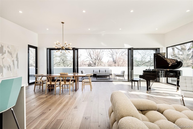 interior space with light hardwood / wood-style floors and an inviting chandelier