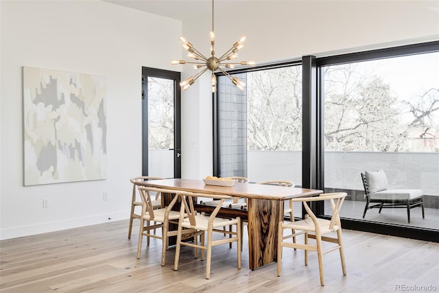 dining room with a notable chandelier and light wood-type flooring