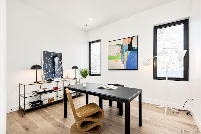 home office featuring a wealth of natural light and light hardwood / wood-style floors