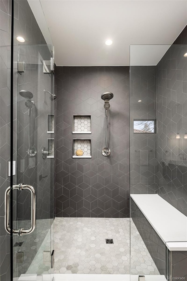 bathroom with a shower with door