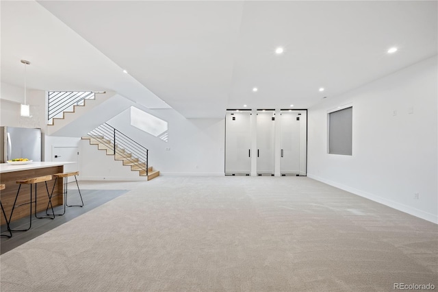 unfurnished living room with light carpet