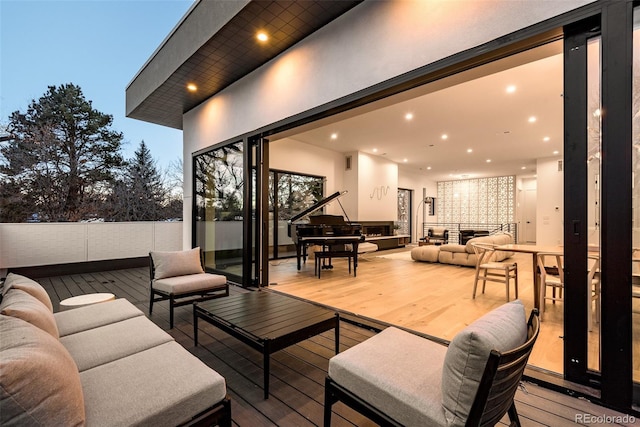 deck at dusk with an outdoor living space