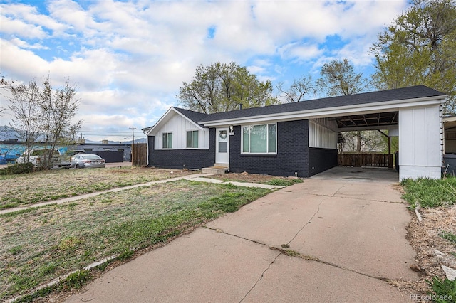 2514 E Bijou St, Colorado Springs, CO 80909 - single story home featuring an attached carport, brick siding, driveway, and board and batten siding