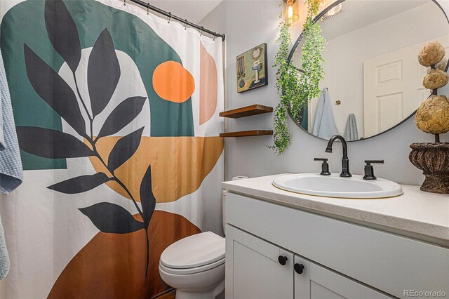 2514 E Bijou St, Colorado Springs, CO 80909 - bathroom with toilet, vanity, and a shower with shower curtain