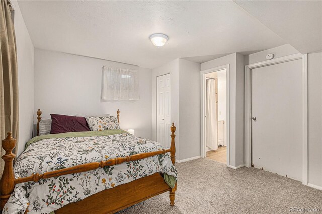 2514 E Bijou St, Colorado Springs, CO 80909 - bedroom featuring light carpet, baseboards, and a closet
