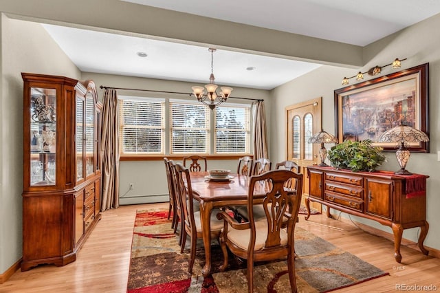 31 Black Fawn Ln, Westcliffe, CO 81252 - dining space with a baseboard radiator, light wood-type flooring, baseboards, and an inviting chandelier