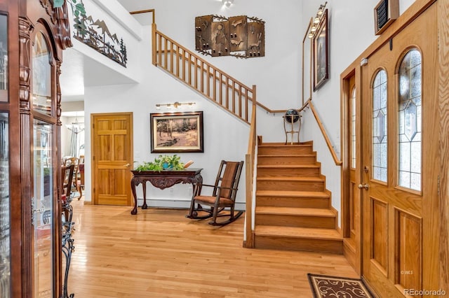 31 Black Fawn Ln, Westcliffe, CO 81252 - entrance foyer featuring light wood-type flooring, a high ceiling, a notable chandelier, and stairway