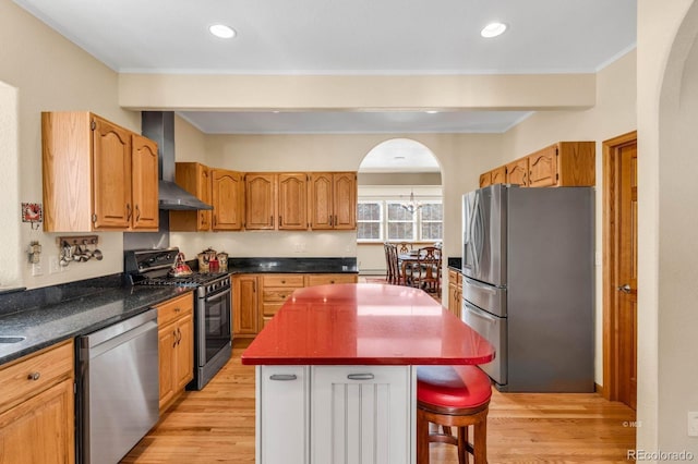 31 Black Fawn Ln, Westcliffe, CO 81252 - kitchen with light wood-style flooring, wall chimney exhaust hood, a kitchen island, and appliances with stainless steel finishes