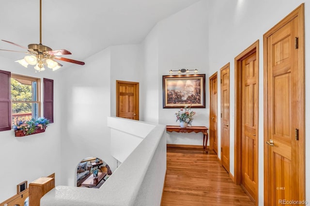 31 Black Fawn Ln, Westcliffe, CO 81252 - hallway with baseboards, vaulted ceiling, an upstairs landing, and light wood-style flooring