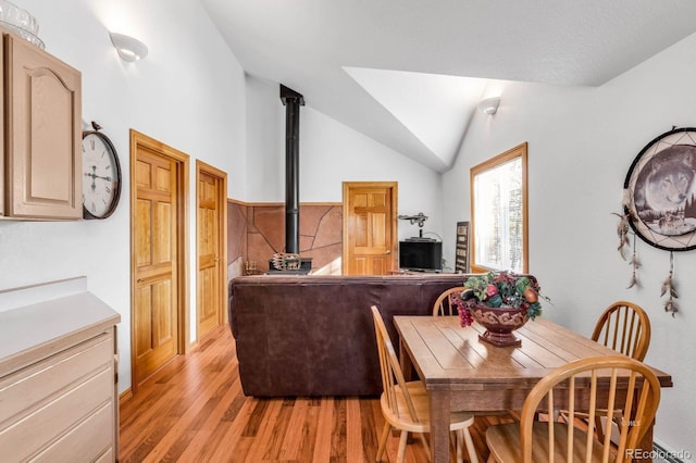 31 Black Fawn Ln, Westcliffe, CO 81252 - dining area with lofted ceiling, a wood stove, and light wood-type flooring