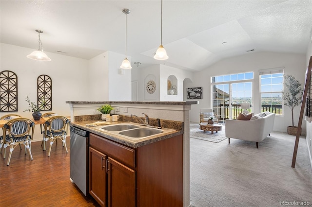 kitchen with sink, hanging light fixtures, vaulted ceiling, stainless steel dishwasher, and a textured ceiling