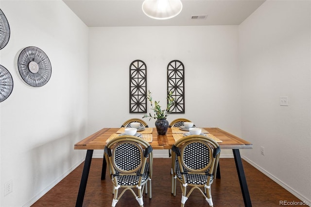 dining room with dark hardwood / wood-style flooring