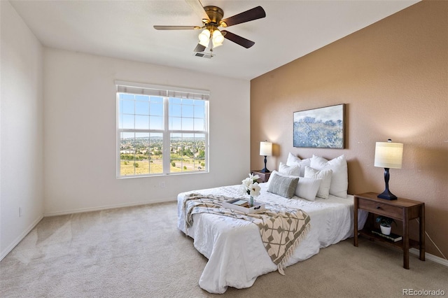 bedroom with ceiling fan and light carpet