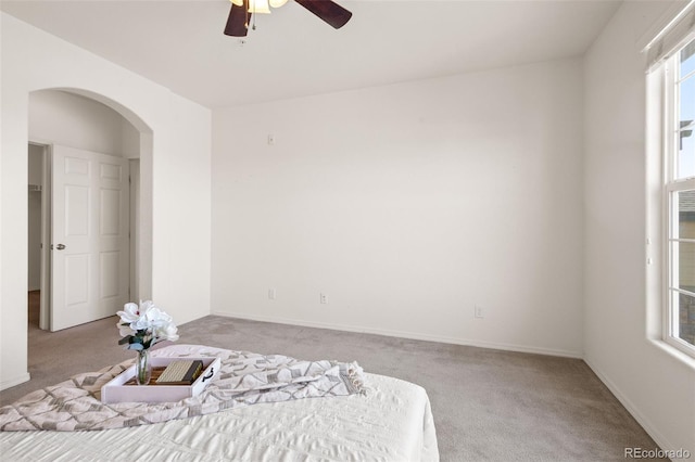 bedroom featuring light colored carpet and ceiling fan