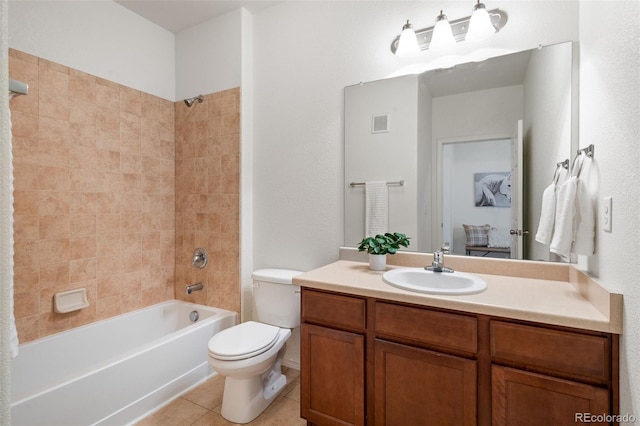 full bathroom featuring tile patterned flooring, tiled shower / bath combo, toilet, and vanity