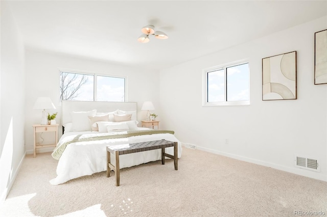 bedroom featuring baseboards, visible vents, multiple windows, and carpet floors