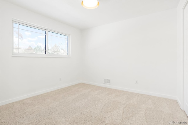 unfurnished room featuring visible vents, baseboards, and carpet