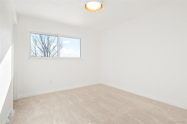 empty room with carpet flooring and baseboards