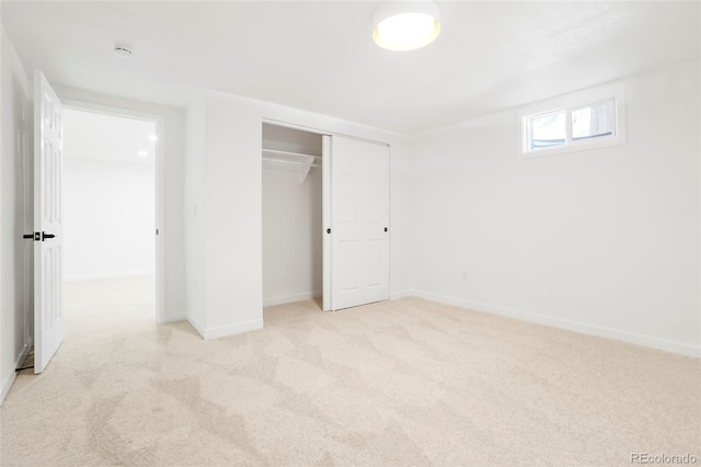 unfurnished bedroom with a closet, baseboards, and carpet