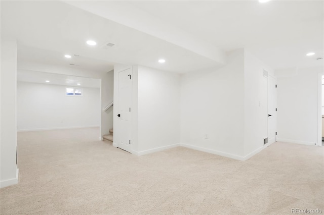 below grade area with recessed lighting, baseboards, and light colored carpet