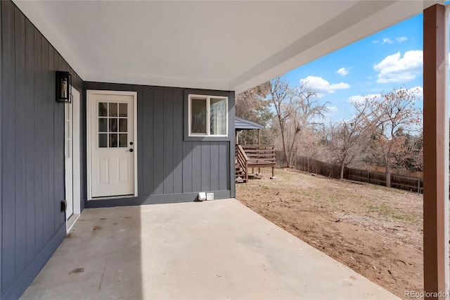 property entrance with a patio area and fence