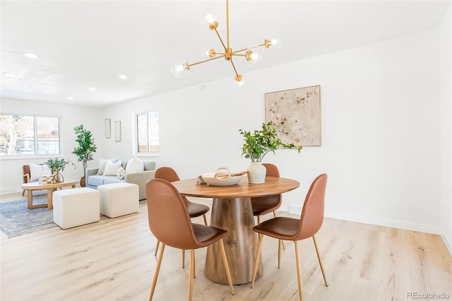 dining space featuring recessed lighting, baseboards, light wood finished floors, and a chandelier