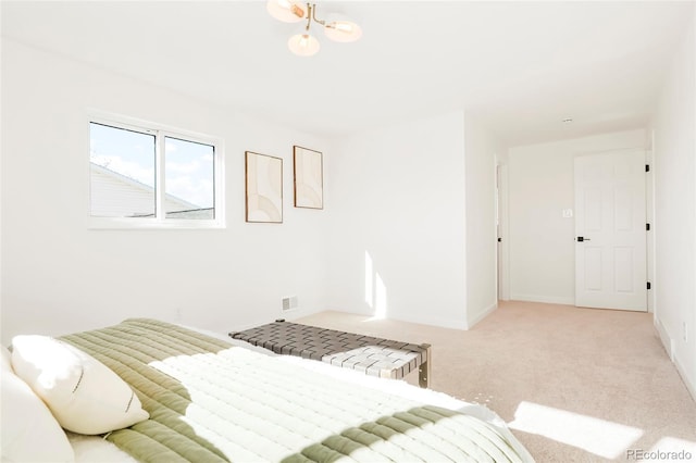 bedroom with a notable chandelier, baseboards, and light colored carpet