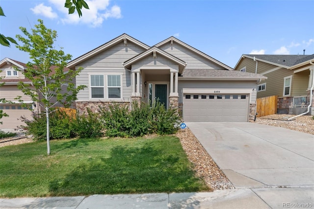 craftsman house featuring a garage and a front yard