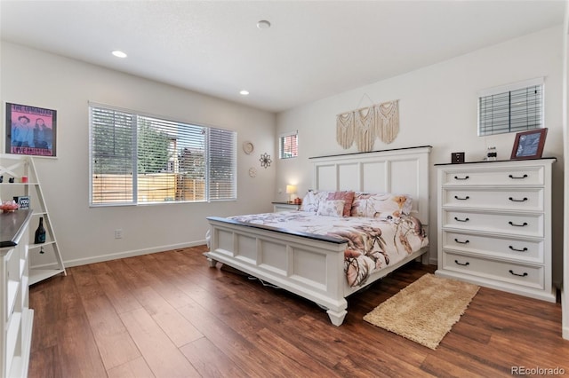 bedroom featuring baseboards, dark wood finished floors, and recessed lighting