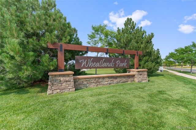 community sign featuring a lawn