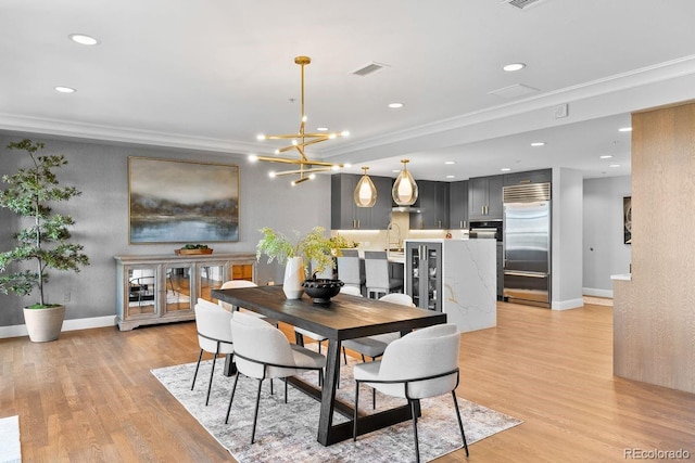 1590 Little Raven St Unit 408, Denver, CO 80202 - dining space featuring ornamental molding, light wood-style floors, visible vents, and recessed lighting