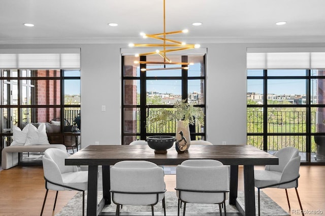 1590 Little Raven St Unit 408, Denver, CO 80202 - dining area featuring an inviting chandelier, wood finished floors, ornamental molding, and recessed lighting