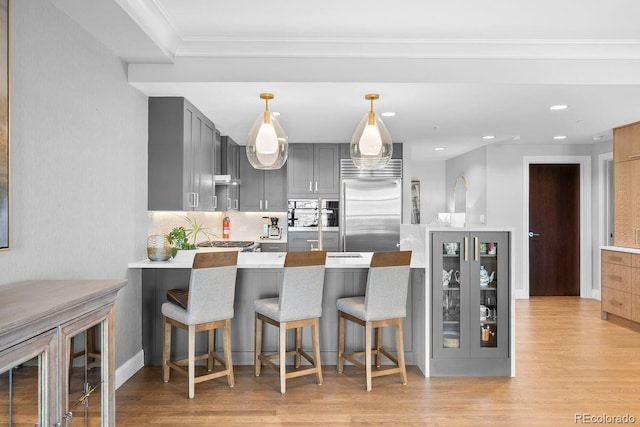 1590 Little Raven St Unit 408, Denver, CO 80202 - kitchen with a peninsula, gray cabinets, stainless steel built in fridge, and light wood-style flooring