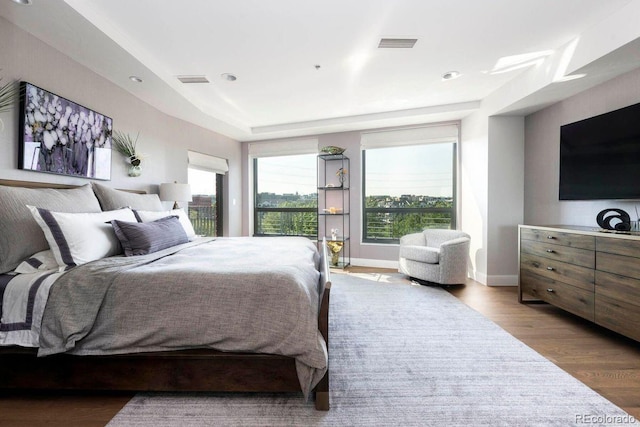 1590 Little Raven St Unit 408, Denver, CO 80202 - bedroom featuring visible vents, wood finished floors, and baseboards