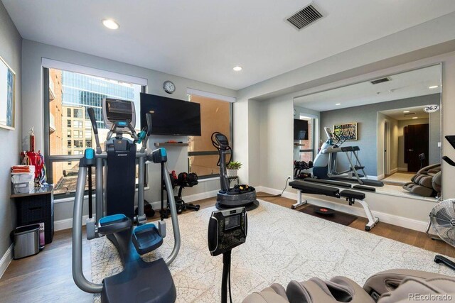 1590 Little Raven St Unit 408, Denver, CO 80202 - exercise room with baseboards, recessed lighting, visible vents, and wood finished floors