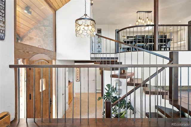 2976 Hiwan Dr, Evergreen, CO 80439 - stairway with a chandelier and vaulted ceiling
