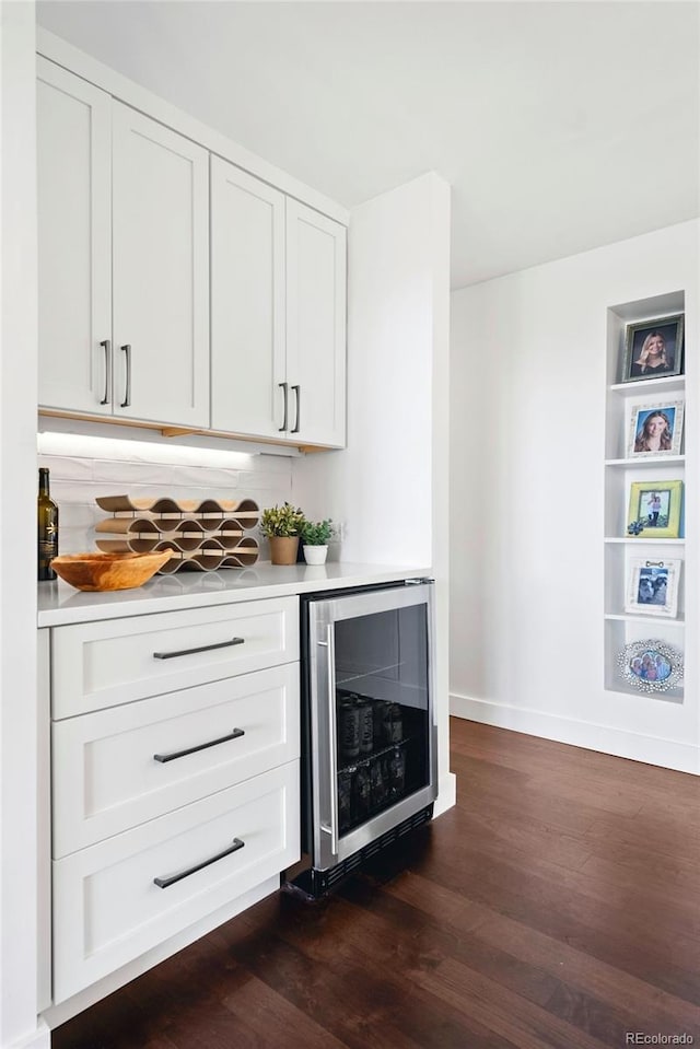 2976 Hiwan Dr, Evergreen, CO 80439 - indoor dry bar with beverage cooler, dark wood-type flooring, and baseboards