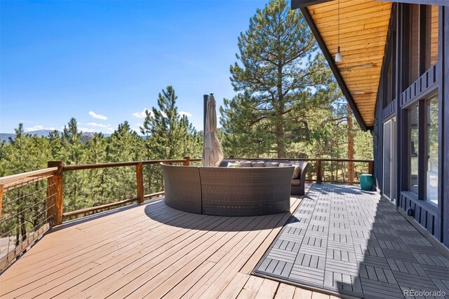 2976 Hiwan Dr, Evergreen, CO 80439 - wooden deck featuring an outdoor hangout area