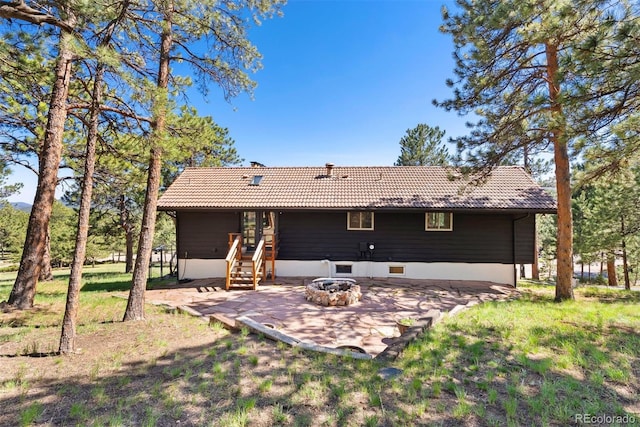 2976 Hiwan Dr, Evergreen, CO 80439 - rear view of house with a tiled roof, a fire pit, and a patio area