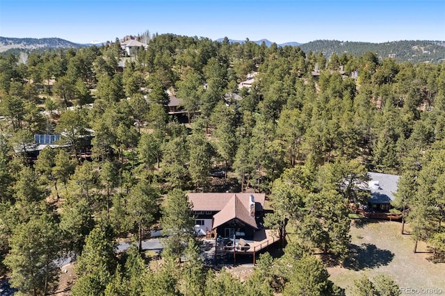 2976 Hiwan Dr, Evergreen, CO 80439 - aerial view of property and surrounding area featuring a heavily wooded area and mountains