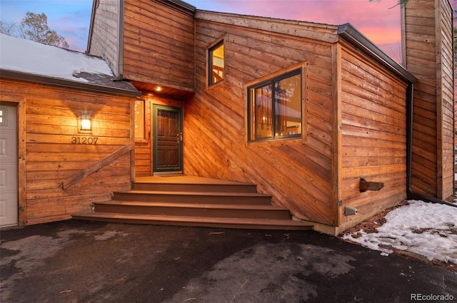 exterior entry at dusk with a garage