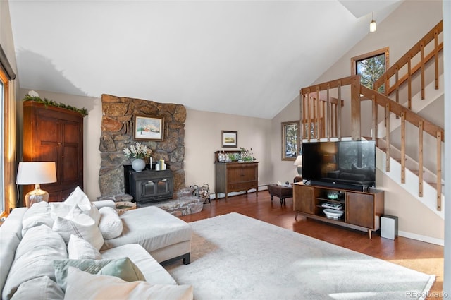 living room with stairway, dark wood finished floors, a wood stove, and baseboards