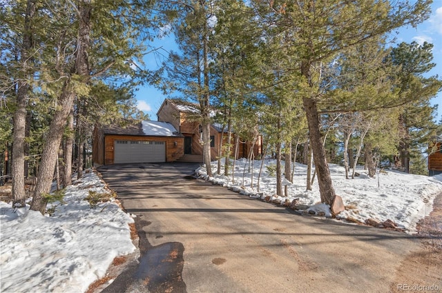 chalet / cabin with concrete driveway and an attached garage