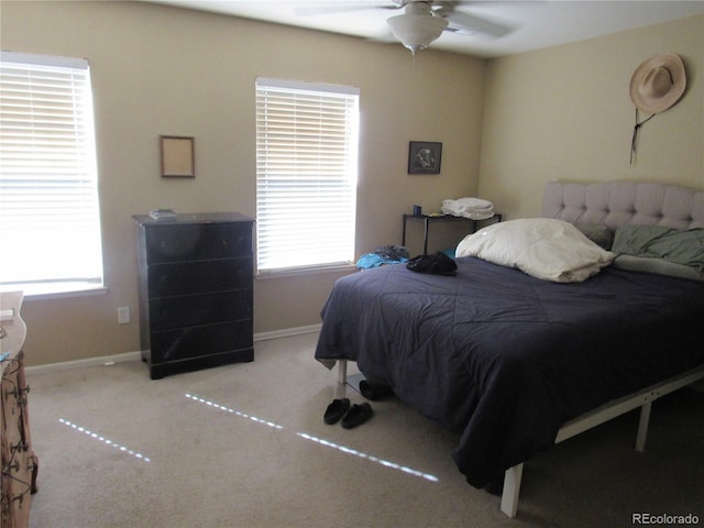 bedroom featuring carpet flooring, multiple windows, and baseboards