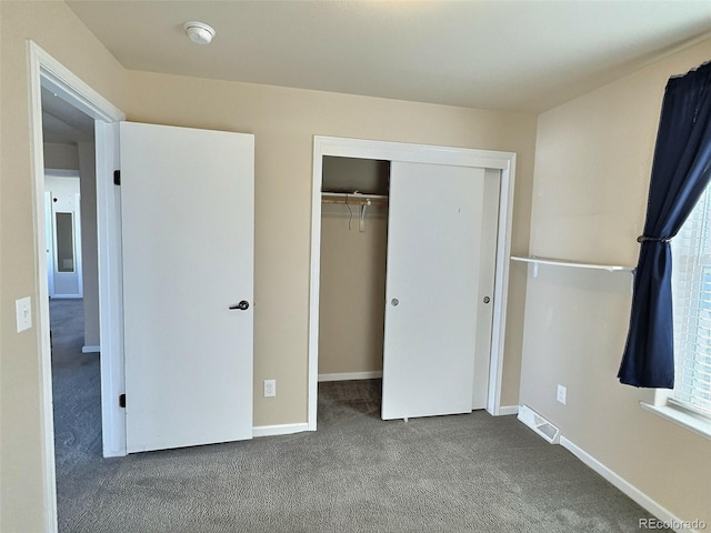 unfurnished bedroom featuring a closet and carpet