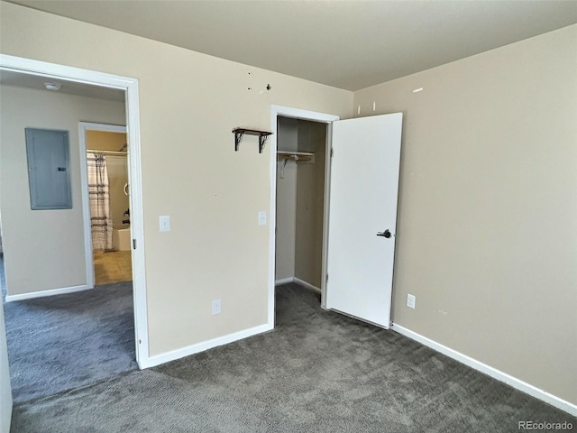 unfurnished bedroom featuring electric panel, dark colored carpet, and a closet