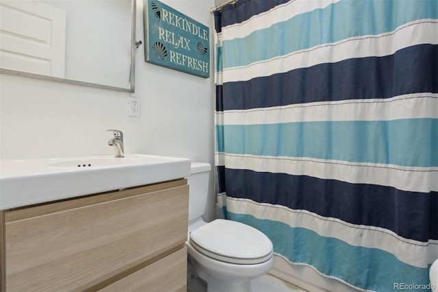 bathroom with toilet and vanity