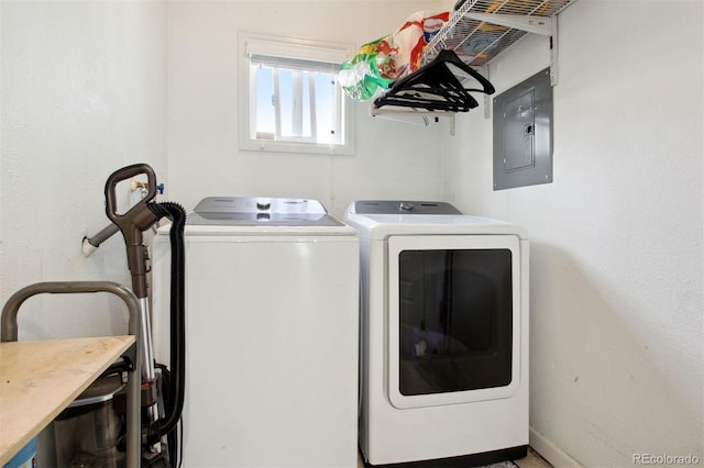 washroom with electric panel and washer and clothes dryer