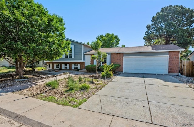 9222 Albion St, Thornton, CO 80229 - split level home featuring brick siding, driveway, and a garage